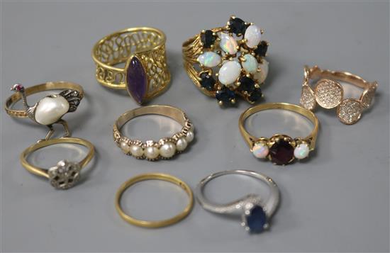 Nine assorted gold and gem set rings including three 18ct, three 14ct and three yellow metal.